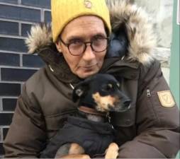 Robert Bartholomey, an Air Force veteran who died in an East Village apartment fire on Feb. 2, holds his beloved dog, Bella, who succumbed to her own injuries five days later.