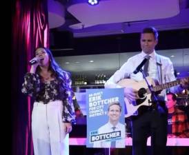 Council member Erik Bottcher sings and plays guitar at a Greenwich Village party on election night, where he was joined by Jacqueline Vier and others celebrating his landslide win. Photo: via X @ebottcher