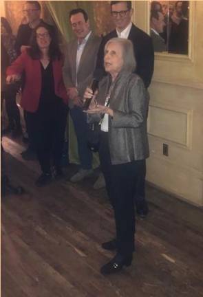 <b>Nancy Haberman (at mic) at her March 12 “retirement” party from Rubenstein Inc. at the Chelsea Hotel which was tossed to by her one time protégé now boss Steven Rubenstein (rear, back of Nancy) and attended by her Pulitzer Prize winning daughter, Maggie Haberman (left), and son journlist/pr man Zach Haberman (center rear) </b>Photo: Keith J. Kelly