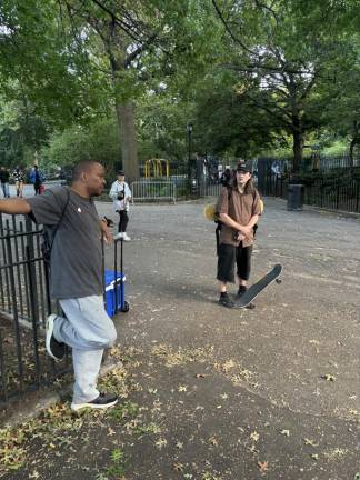 Skateboard enthusiast Wayne “G Man” Allen (left) talks with Chris, a skateboarder who was visiting from England and had heard about the skateboard mecca in the East Village. Alas, it was closed for renovation when he stopped by Tompkins Square Park on Sept. 2 with his skateboard.