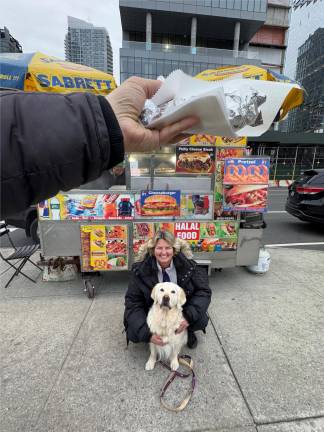 Maui a nine-year-old Golden Retriever with owner Sabrina Lanz and a free hotdog from a street vendor.