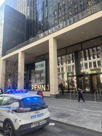 A police cruiser remains on the scene at 1 Penn Plaza on Feb. 25, less than 24 hours after a 26 year old man plunged to his death from the tallest building in the Penn Plaza complex.