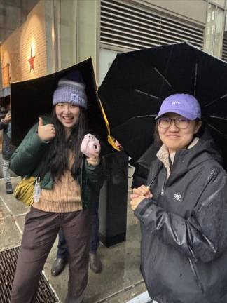 Sue (left) and Bin Bin are from China studying at NYU and enjoyed their first ever Thanksgiving Day parade, despite the steady rain.