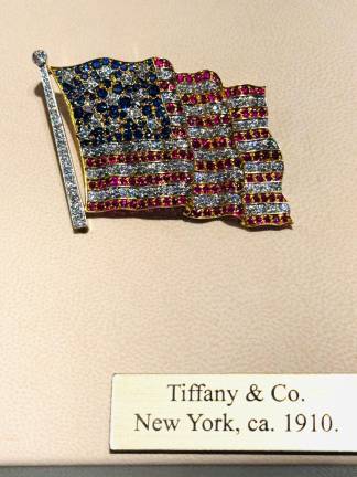 Early Tiffany and Co. ruby, sapphire and diamond American flag brooch. American, circa 1910, at the gallery A La Vieille Russie.