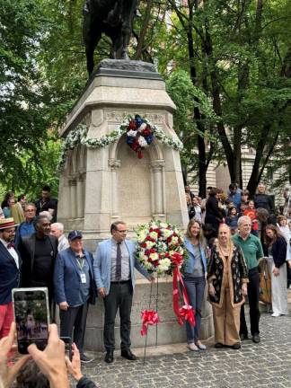 <b>Community members gathered around the statue in Joan of Arc Park for its rededication on May 18, celebrating the legacy of the famous heroine and the group's efforts to restore the iconic sculpture. </b>