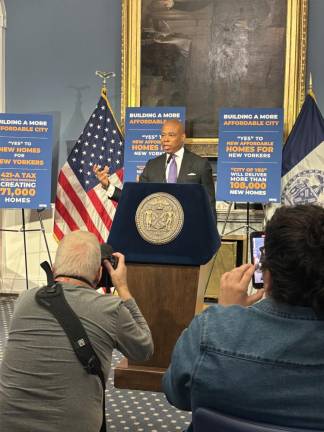 Mayor Eric Adams, back in the blue room at City Hall at his weekly press briefing, but was not flanked by his usual assortment of deputy mayors as he was before his indictment on Sept. 26. He said he has discussed a school cell phone with his new education chancellor, but nothing is imminent.