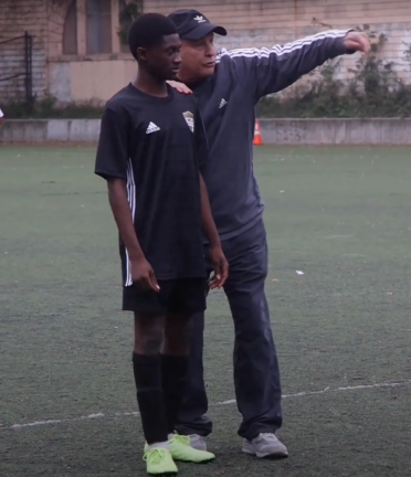 Jacobson coaching one of his players after a 2023 game.