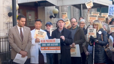 Village Preservation Executive Director Andrew Berman (center) helms an October 15 rally on landmarking New York Eye &amp; Ear Infirmary. He noted its historical salience as a center for the disabled community.