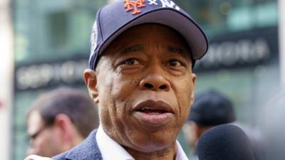 A Mayor for All Post-Seasons: Paying tribute to both of the city’s playoff teams, Eric Adams wore a startling dual-logo Mets / Yankees baseball cap at the Columbus Day Parade, October 14, 2024.