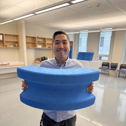 Victorino poses in “The Block Room” with one of the large blue blocks that P.S. 150 utilizes as education enrichment, meant to teach skills in building, teamwork, and creativity. The principal also sees this enrichment as vital to children’s socialization.