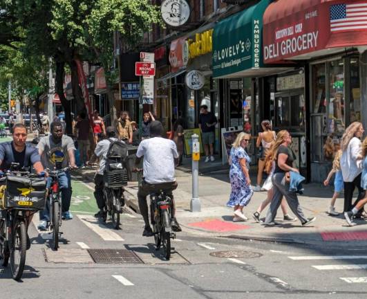 There is no “wrong way” for e-bikes, apparently. 9th Avenue and W. 45th St, June 19, 2024. No the small red “Wrong Way” traffic sign, which seems to be of no concern to the two bikers heading north on the south bound bike lane.