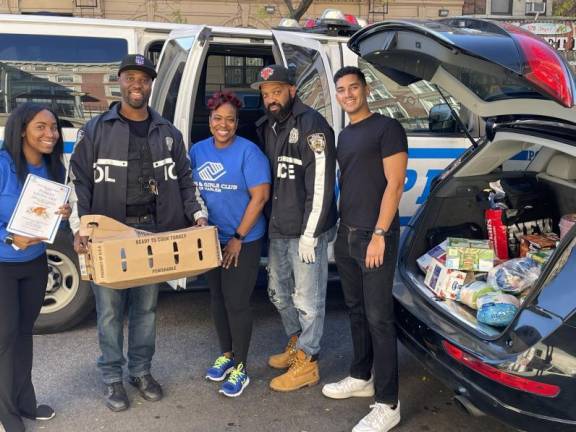 Staff and police officers on the Boys &amp; Girls Club’s Turkey Giving Day.