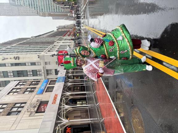 Two of Santa’s helpers who rode on the Jolly Old Elf’s float head home after a long and wet, but enjoyable, day.