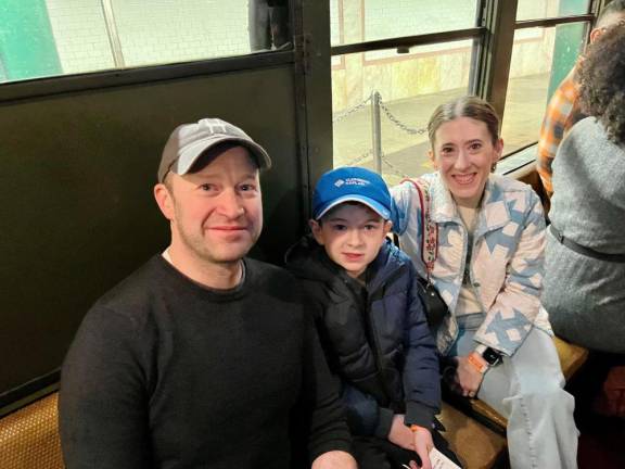 Young Marshall Kaplan (center, blue cap), bookended by his parents, told them how badly he wanted to ride this Anniversary Train on October 27.