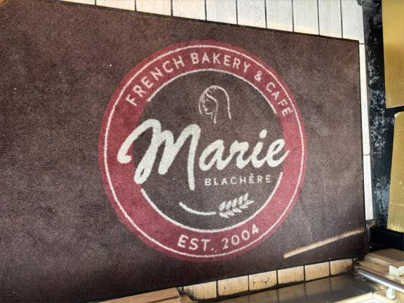 The door mat near the entrance of Marie Blachere in the West Village, tells of the bakeries establishment in 2004.