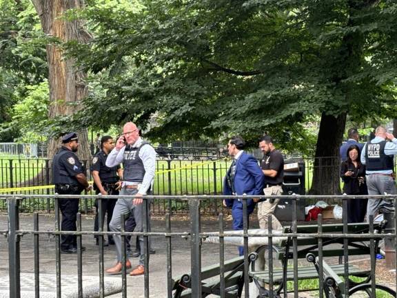 Police in the south end of Tompkins Sq. Park on July 12 after one person that police suspect was a drug dealer was murdered at one of the chess tables shortly before 10 a.m. and a second man described as a “steerer” for the drug dealer was wounded. Police have since arrested two men on murder charges.