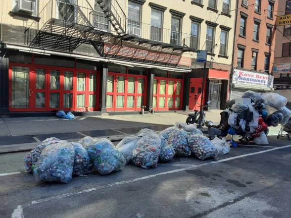 Without an operating business, a homeless individual and his worldly possessions sprawl in front of this long- vacated restaurant.