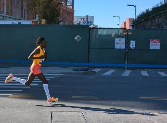 Eventual 3rd place finisher, Vivian Cheryuiot on E. 138th Street, the Bronx, just before she hits the Madison Avenue Bridge back to Manhattan.