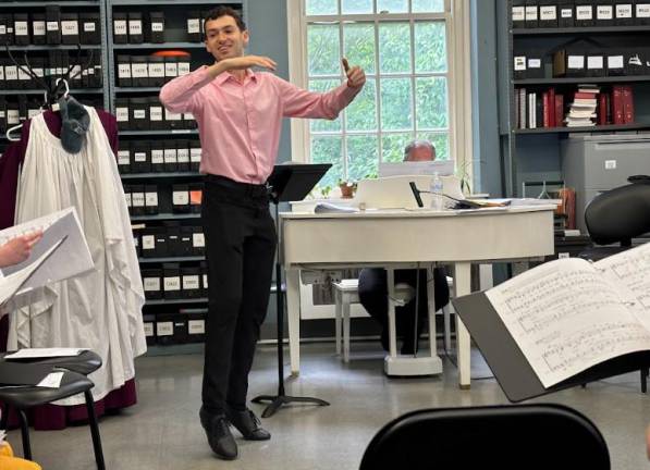 <b>Daniel Facarri conducts during a rehearsal for Pride Choral Evensong at the Cathedral of St. John the Devine.</b> Photo: Carrene Gepilano