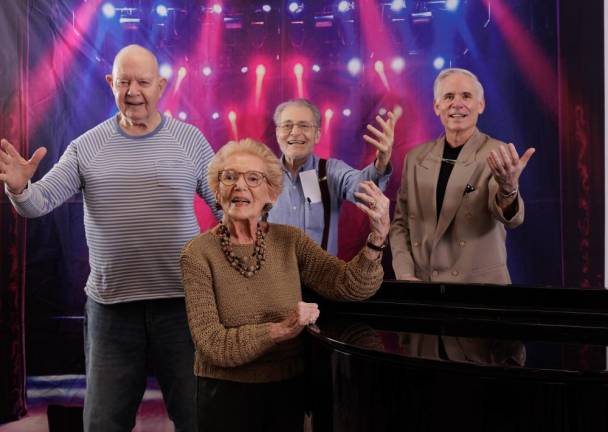 Seniors gather around the piano for a sing-a-long at Carnegie East