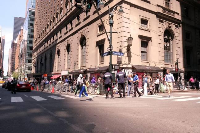 Asylum-seekers queuing up near the Roosevelt Hotel in Midtown Manhattan in July 2023. On Dec. 10, Mayor Eric Adams announced that six migrant shelters in Manhattan would be closing in the next two months.