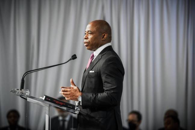 Mayor Eric Adams speaking at The Real Deal‘s Real Estate Showcase + Forum on May 19, an industry event, with a copy of “The New Kings of New York” by Adam Piore on the lectern. Photo: Paul Dilakian/ The Real Deal