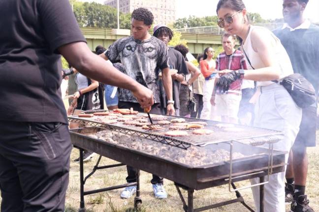 Attendees at the front of the barbeque line for Juneteenth at As Black As It Gets!. Photo: Beau Matic