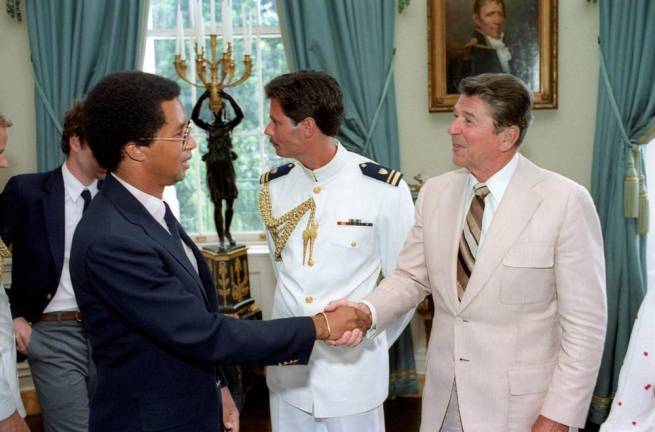 7/19/1982 President Reagan shaking hands with Arthur Ashe at a White House Blue Room event for the United States Davis Cup tennis team