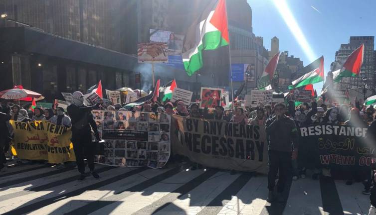 <b>A group of about 400 pro Palestine protestors march up Eighth Ave. as the parade is ending and eventually made their way to the New York Public Library. It is one of three pro-Palestine protests around the parade.</b> Photo: Keith J. Kelly