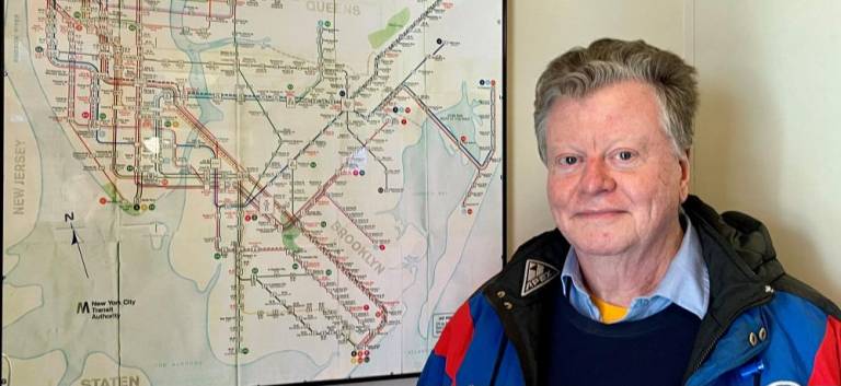 Bruce Caulfield in front of a subway map in the current Tracks on W. 31st. The new Tracks will continue with the railroad motif. Photo: Ralph Spielman