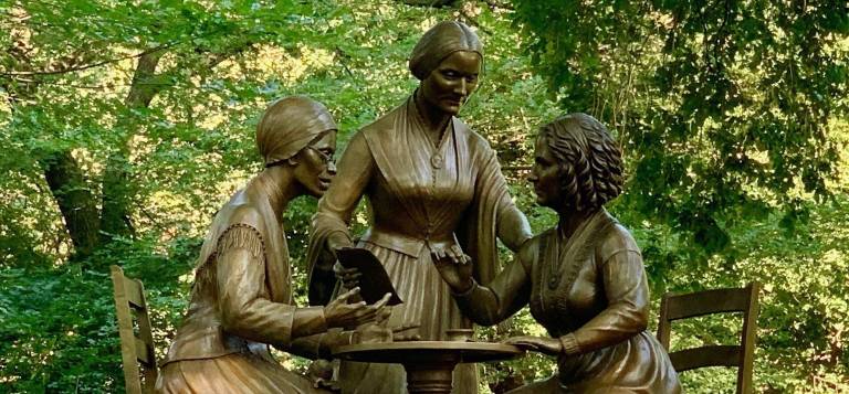 The monument honors three women activists: (from left to right) Sojourner Truth speaking, Susan B. Anthony organizing, and Elizabeth Cady Stanton writing.