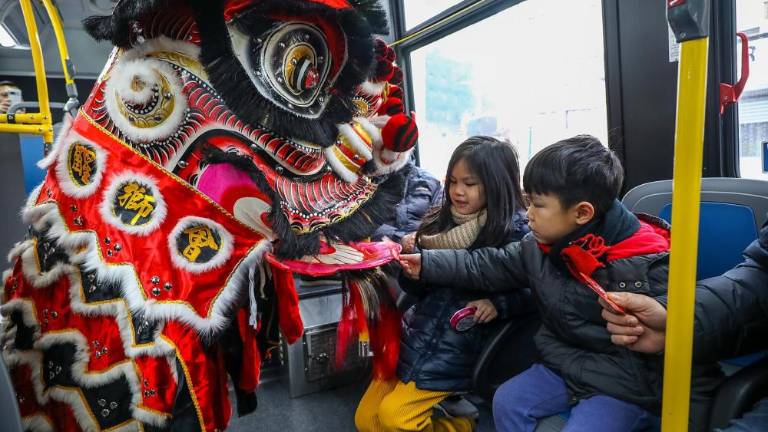 Dancers, “disguised” as a lion, bring blessings and good fortune to MTA riders in January 2023.