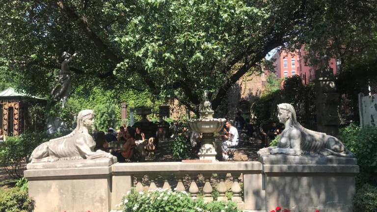 The sphinx statues at the entrance of the Elizabeth St. Garden.