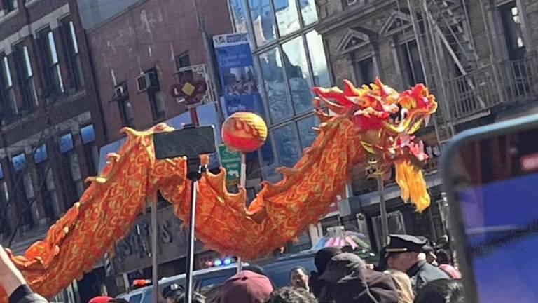 A dragon flies along Mott Street.